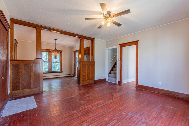 unfurnished living room with ornamental molding, a baseboard radiator, dark hardwood / wood-style floors, and ceiling fan with notable chandelier