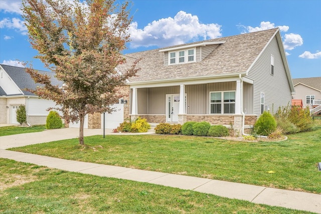 view of front of home with a garage, a front yard, and a porch