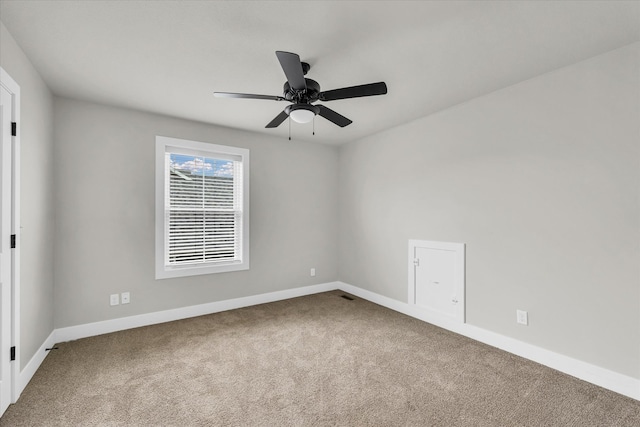 carpeted spare room with ceiling fan