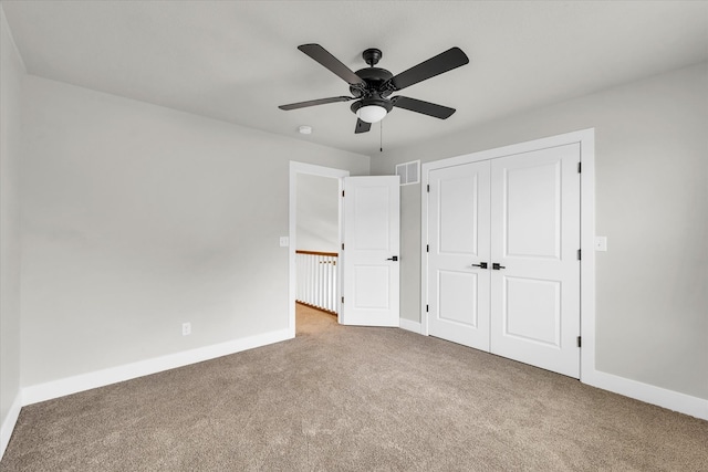 unfurnished bedroom featuring ceiling fan, light carpet, and a closet