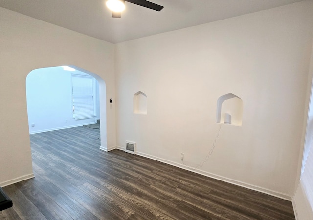 spare room with dark hardwood / wood-style floors and ceiling fan