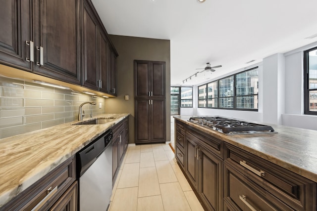 kitchen with tasteful backsplash, stainless steel appliances, wooden counters, sink, and ceiling fan