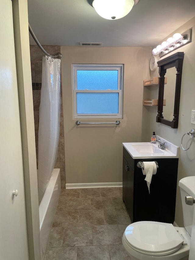 full bathroom featuring shower / bath combo with shower curtain, vanity, and toilet