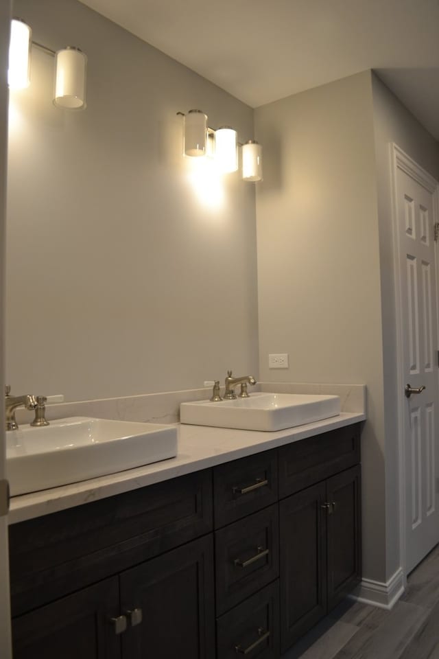 bathroom with hardwood / wood-style flooring and vanity