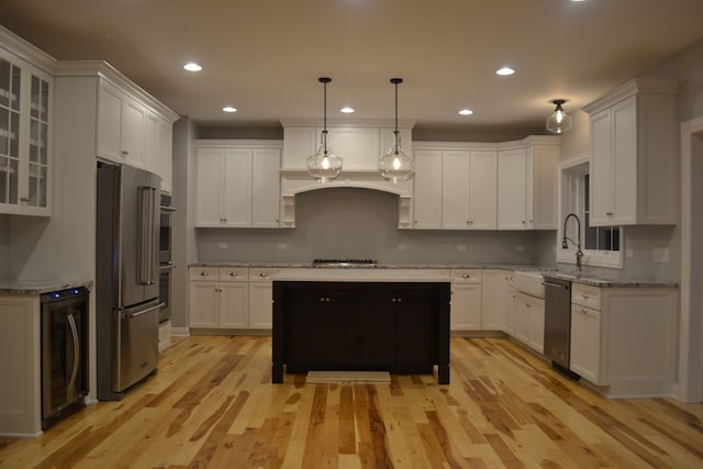 kitchen with white cabinets, light wood-type flooring, stainless steel appliances, and wine cooler