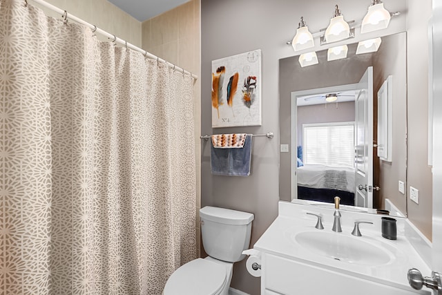 bathroom with vanity, ceiling fan, and toilet