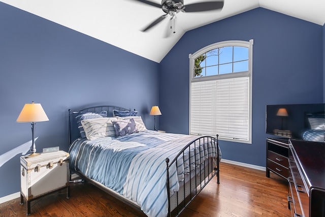 bedroom with dark hardwood / wood-style flooring, vaulted ceiling, and ceiling fan