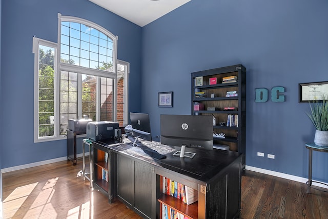 office featuring a high ceiling and dark hardwood / wood-style floors