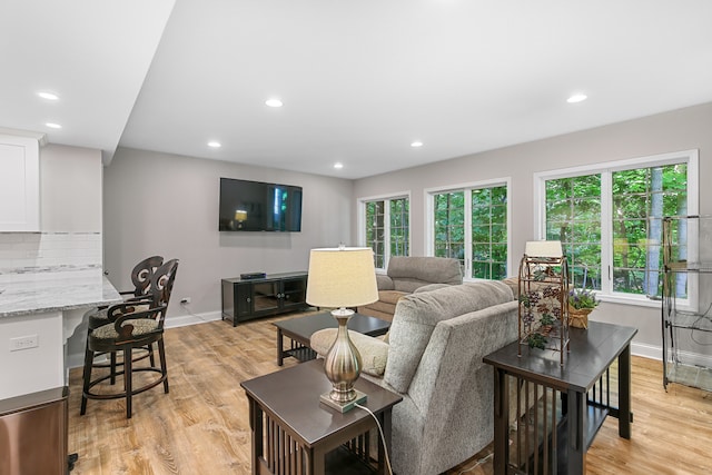 living room featuring built in desk and light hardwood / wood-style floors