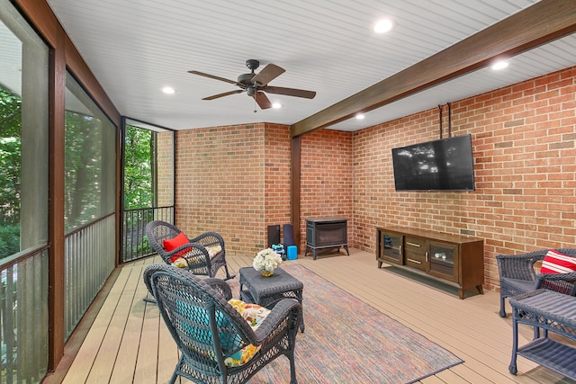 sunroom featuring beamed ceiling and ceiling fan