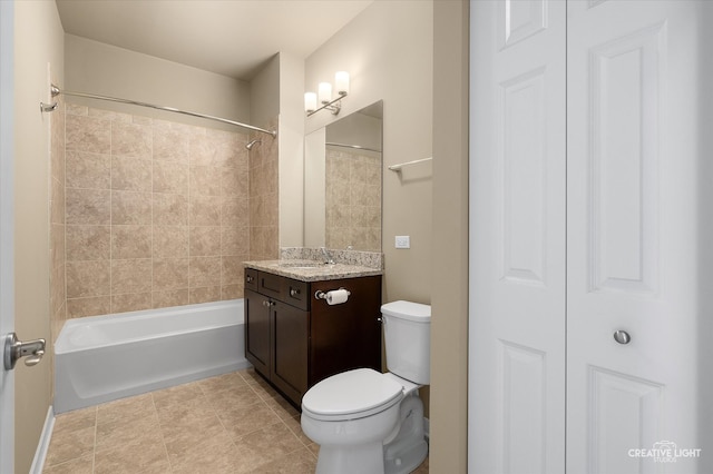 full bathroom featuring toilet, vanity, tiled shower / bath, and tile patterned floors