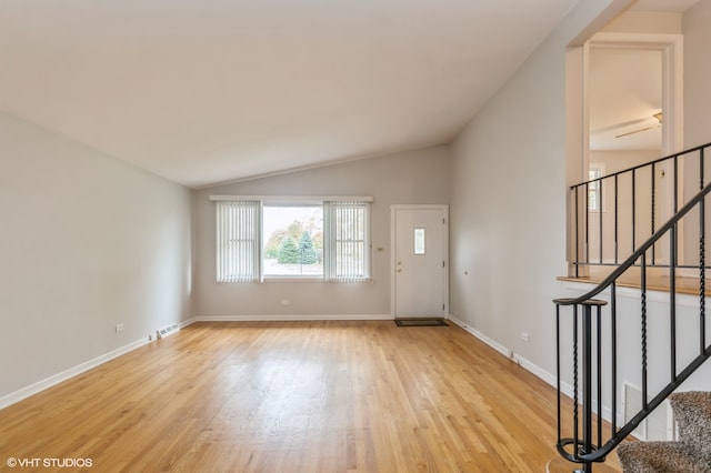 foyer featuring vaulted ceiling and light hardwood / wood-style flooring