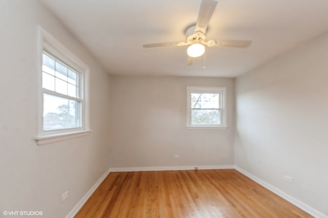 unfurnished room with hardwood / wood-style floors and ceiling fan