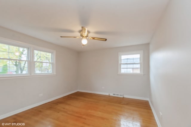 spare room featuring ceiling fan and light hardwood / wood-style flooring