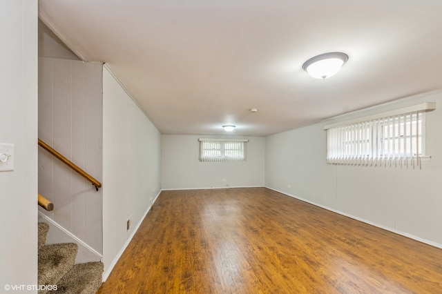 empty room with wood walls and wood-type flooring