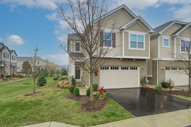 view of front of house with a garage and a front lawn