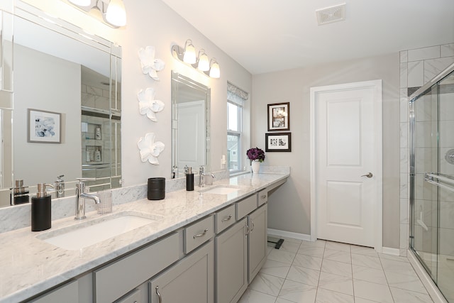 bathroom with vanity and a shower with door