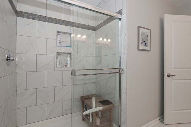 bathroom with tile patterned flooring and a shower with shower door