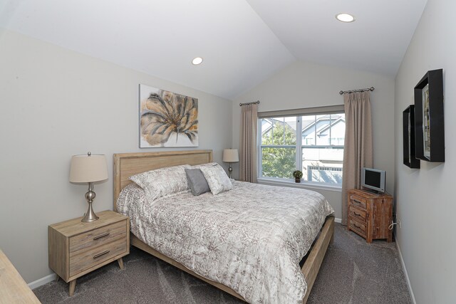 bedroom featuring dark colored carpet and vaulted ceiling