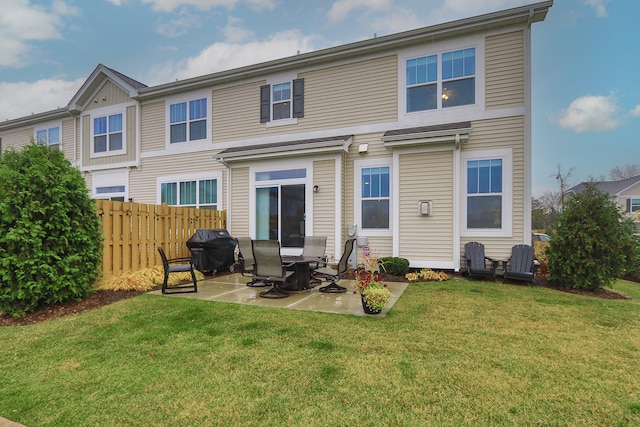 rear view of house with a yard and a patio area