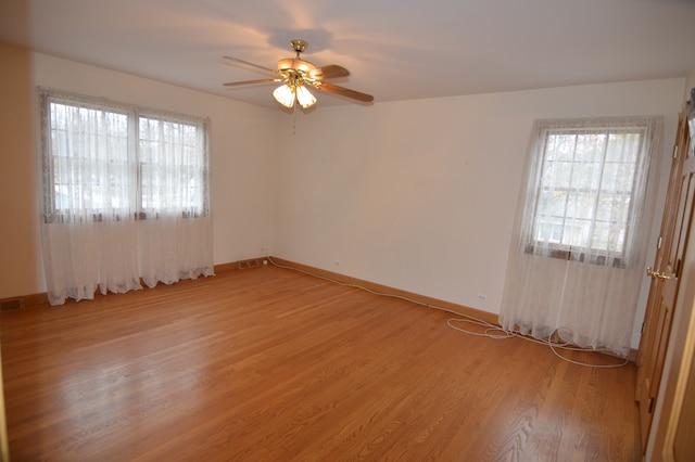 empty room featuring wood-type flooring and ceiling fan