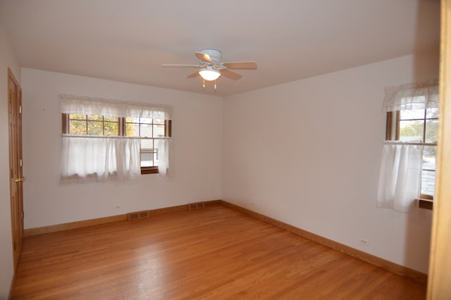 unfurnished room with ceiling fan and light hardwood / wood-style flooring