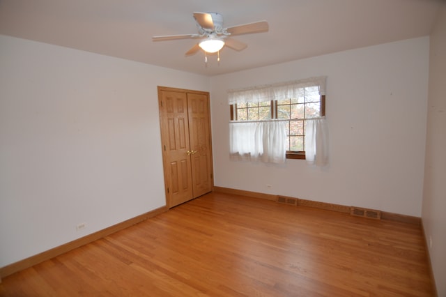 spare room with hardwood / wood-style floors and ceiling fan