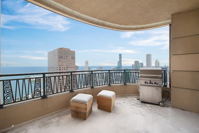 balcony featuring area for grilling and a water view