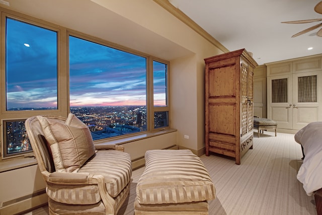 bedroom featuring light carpet, ceiling fan, and crown molding