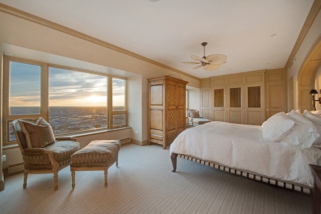 bedroom featuring ceiling fan, a closet, and crown molding