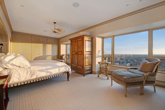 bedroom with light colored carpet, ceiling fan, and crown molding