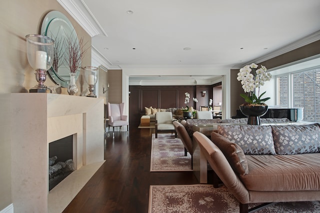 living room featuring dark wood-type flooring, a high end fireplace, and ornamental molding