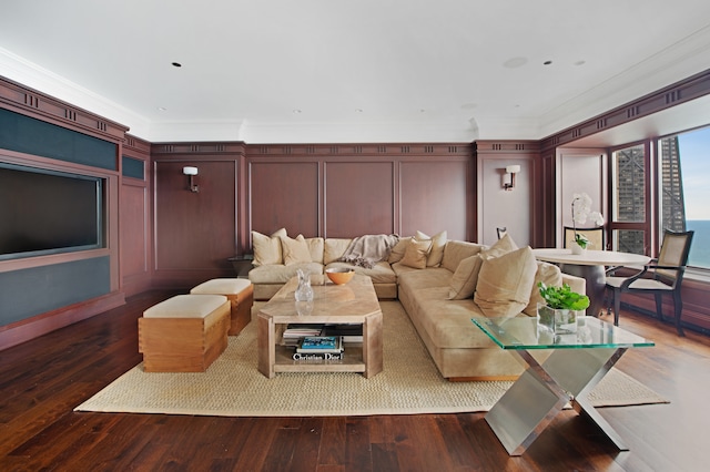 home theater room featuring dark hardwood / wood-style flooring and ornamental molding