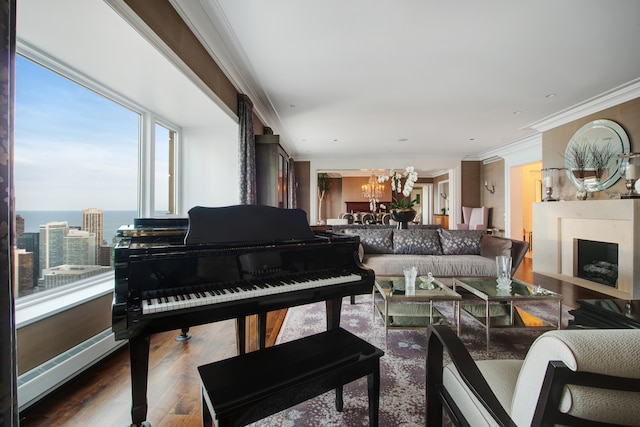 misc room with ornamental molding, hardwood / wood-style floors, a water view, and a chandelier