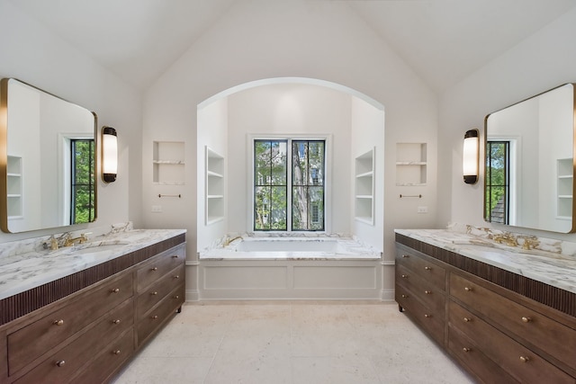 bathroom featuring plenty of natural light, built in shelves, and vaulted ceiling