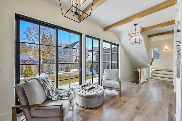 sitting room with beamed ceiling, light hardwood / wood-style flooring, and a healthy amount of sunlight