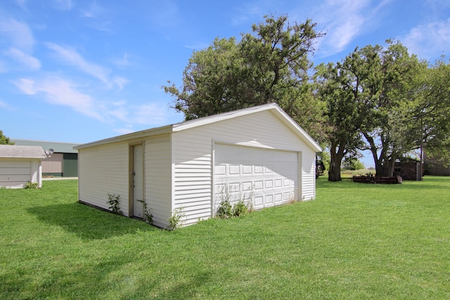 garage featuring a lawn