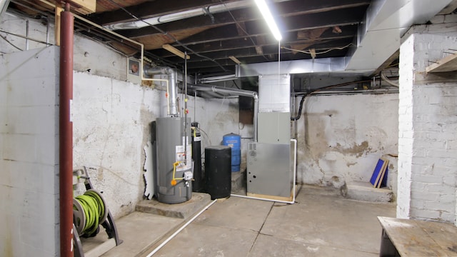 basement featuring water heater and heating unit