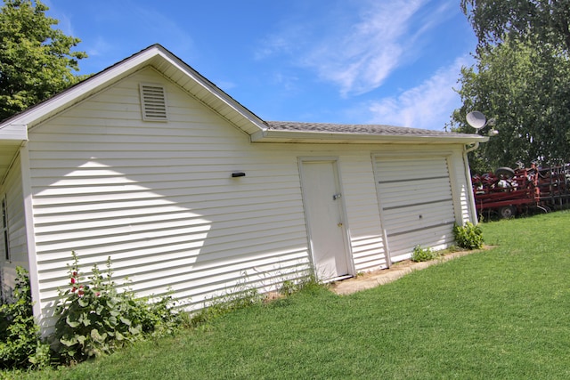 garage featuring a lawn