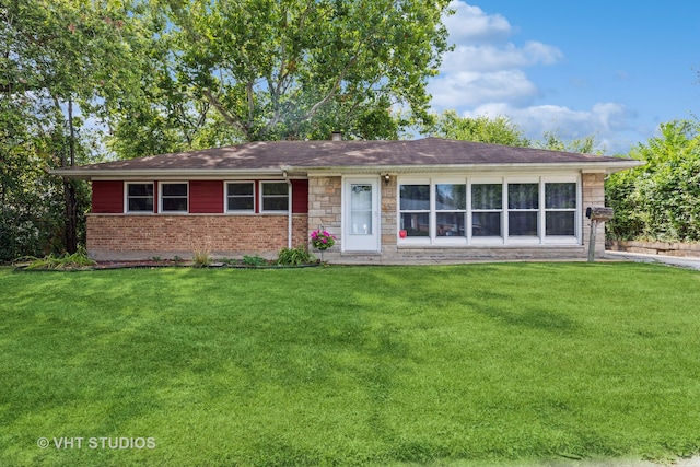 ranch-style home with a front lawn