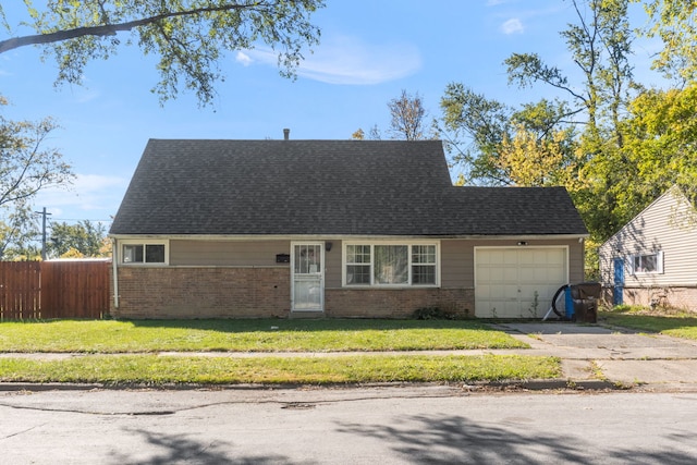 view of front of property featuring a garage and a front yard