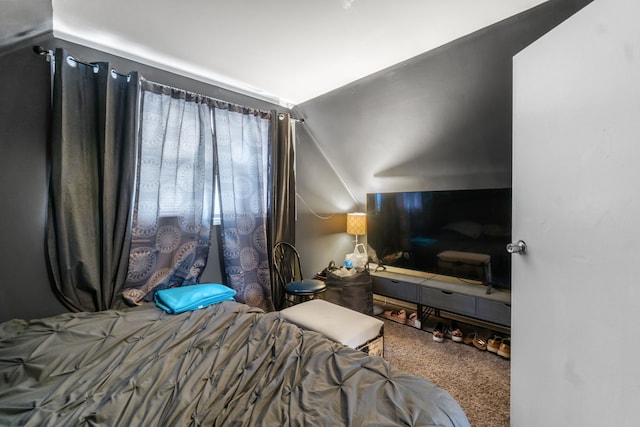 carpeted bedroom featuring lofted ceiling