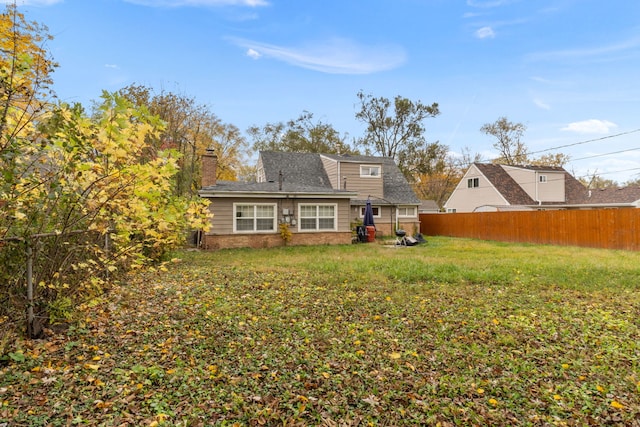 rear view of property with a lawn