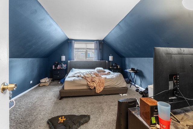 carpeted bedroom with lofted ceiling