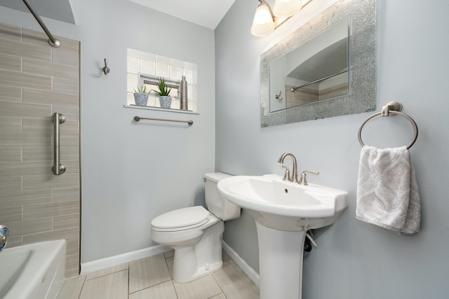 bathroom featuring tile patterned flooring, tiled shower / bath combo, and toilet