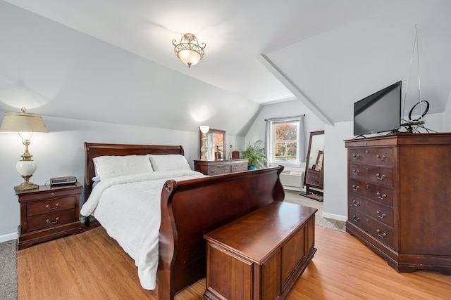 bedroom with light wood-type flooring and lofted ceiling