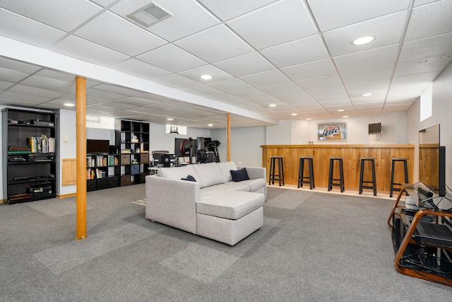 living room with carpet and a paneled ceiling