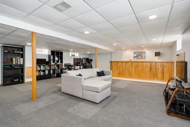 living room with carpet flooring and a drop ceiling