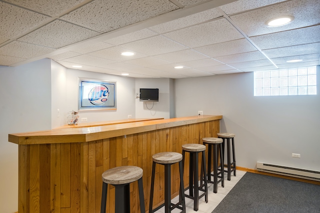 bar with a paneled ceiling and a baseboard radiator