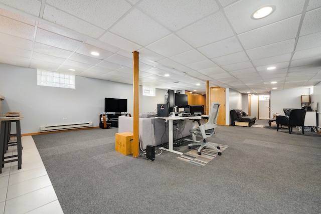 exercise area featuring carpet floors, a drop ceiling, and a baseboard heating unit